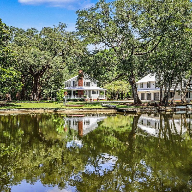 The lake and the two houses at Oak Grove, a 12-acre listing in Ravenel
